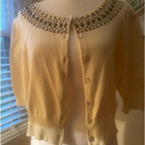 Cute neutral/beige Shrug with copper colored detailing around neckline
